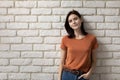 Portrait attractive young woman on white brick wall background Royalty Free Stock Photo