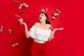 Portrait of attractive youth looking windfalling banknotes scream laugh isolated over red background