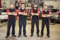 Portrait of auto shop mechanics group together employee