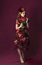 Portrait of autumn floral fantasy woman holding a bouquet