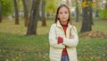 Portrait in autumn park outdoors alone offended sad serious confident Caucasian child girl kid daughter children Royalty Free Stock Photo