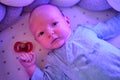 Portrait of a baby boy aged 1 month lying with his eyes open in a crib. Caucasian child in the children bedroom on the bed Royalty Free Stock Photo