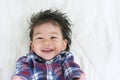 Portrait Baby Boy Asia Smile on Bed with space for text. Royalty Free Stock Photo