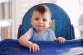 Mommy, can I have seconds. Portrait of a baby boy in his high chair. Royalty Free Stock Photo