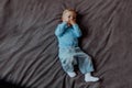 Portrait of a baby boy lying on grey background Royalty Free Stock Photo