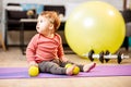 Baby boy portrait with dumbbells and fitness ball at home Royalty Free Stock Photo