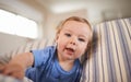 Portrait, baby boy and smile in sofa relaxing, resting and playing in living room. Newborn, growth and development at Royalty Free Stock Photo