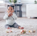 Portrait, baby and building blocks toy on a floor for learning, playing and fun in her home. Face, toddler and girl with Royalty Free Stock Photo