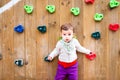 Portrait of baby in a children`s playground with climbing wall Royalty Free Stock Photo