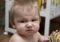 Portrait of a baby with disgust facial expression