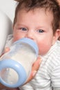 Baby drinking milk of her bottle