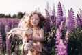 Portrait of a baby girl with a doll. Holidays and trips with family out of town on nature. Royalty Free Stock Photo