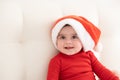 portrait baby girl 6 month in red bodysuit and Santa hat. minimalist. Royalty Free Stock Photo