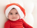 portrait baby girl 6 month in red bodysuit and Santa hat. minimalist. Royalty Free Stock Photo