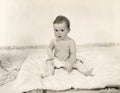 Portrait of baby girl sitting on blanket