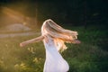 Portrait of a baby girl spinning in a field in sunset light Royalty Free Stock Photo