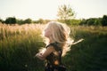 Portrait of a baby girl spinning in a field in sunset light Royalty Free Stock Photo