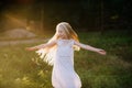 Portrait of a baby girl spinning in a field in sunset light Royalty Free Stock Photo