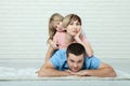 Portrait of baby and her parents lying on carpet in living room