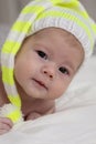 Portrait of baby 2 months child with a striped cap, close-up portrait soft focus. little baby girl boy newborn Royalty Free Stock Photo