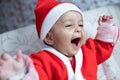 Portrait of infant Baby smiling in Santa costume