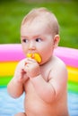 Portrait of a baby in a swimming pool in the summer