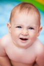 Portrait of a baby in a swimming pool in the summer