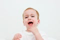 Portrait baby 1 years old open mouth with milk teeth on white background. Drool is drooling from his mouth