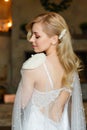 Portrait from the back of a beautiful blonde and sexy bride with an attractive body, dressed in elegant white lace underwear. Royalty Free Stock Photo