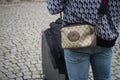portrait on back view of man wearing a gucci bag in the street