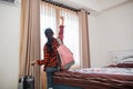 portrait from back of woman with upward clenched hand in hotel room Royalty Free Stock Photo