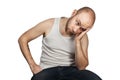 Portrait a bald guy in a white t-shirt sits on a chair and thinks about problems with money, loneliness, payments, work and