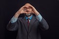 Portrait of bald male business man on dark background. Man in his 40s with grey beard, wearing classic suit, blue shirt, and red Royalty Free Stock Photo