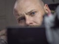 Portrait of a bald man with a beard with beautiful blue eyes, looking away from the camera. man makes selfie Royalty Free Stock Photo