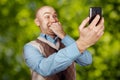 Portrait Bald man talking on the phone and selfie on green bokeh background Royalty Free Stock Photo