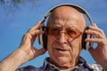 Portrait of a bald retired man listening music Royalty Free Stock Photo