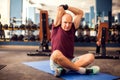 A portrait of senior man doing stretching after training in the gym. People, healthcare and lifestyle concept Royalty Free Stock Photo