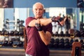 A portrait of senior man doing workout before training in the gym. People, healthcare and lifestyle concept Royalty Free Stock Photo