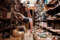 Portrait of ballerina girl in vintage book store wearing casual clothes Royalty Free Stock Photo