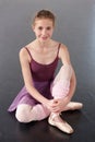 Portrait, ballerina and happy girl on floor in studio to practice, student exercise or education. Ballet, young teenager Royalty Free Stock Photo