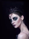 Portrait of the ballerina in the role of a black swan on black background Royalty Free Stock Photo