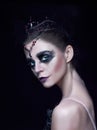 Portrait of the ballerina in the role of a black swan on black background Royalty Free Stock Photo