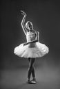 Portrait of ballerina in tutu and pointe shoes making a beautiful pose. Black and white photography. Graceful ballet dancer or