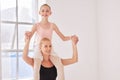 Portrait of ballet teacher carrying girl student with smile in a dance classroom or studio. Woman and young ballerina Royalty Free Stock Photo