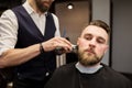 Barber trimming young man