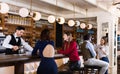 Portrait of barman and people who are standing near bar counter in luxurious restaurant Royalty Free Stock Photo