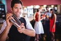 Bartender shaking cocktail mixer in nightclub Royalty Free Stock Photo