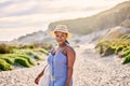 Portrait, beach or black woman on holiday to relax on vacation break in Greece at sunset in summer. Tourist, girl or