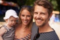 Portrait, beach and family with a kid, vacation and parents with happiness, summer and weekend break. Face, mother and Royalty Free Stock Photo