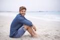 Portrait, beach and man with a smile, holiday and summer vacation with weekend break and water. Waves, face and person